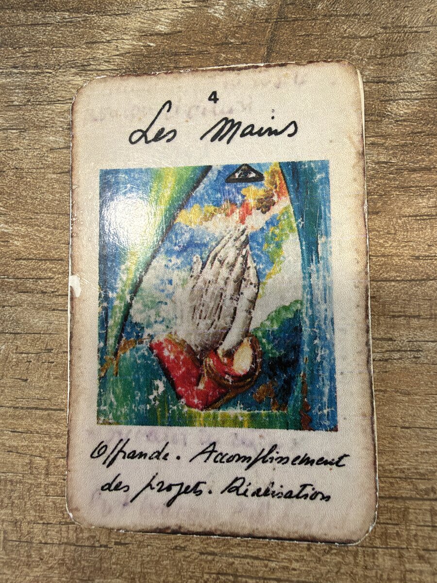 La carte d'origine Les Mains, photographiée, usée et annotée à la main.